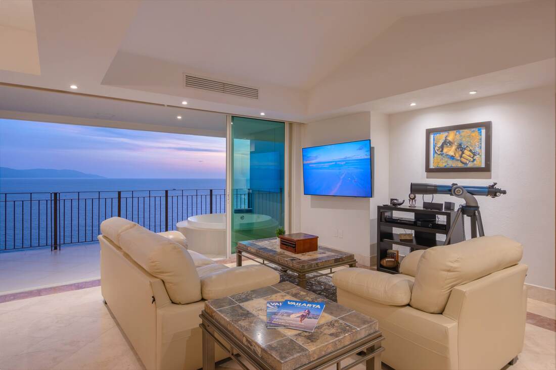 Great room with ocean-view terrace beyond