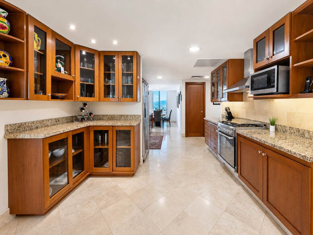 Chef's kitchen with granite counters and glass cabinetry
