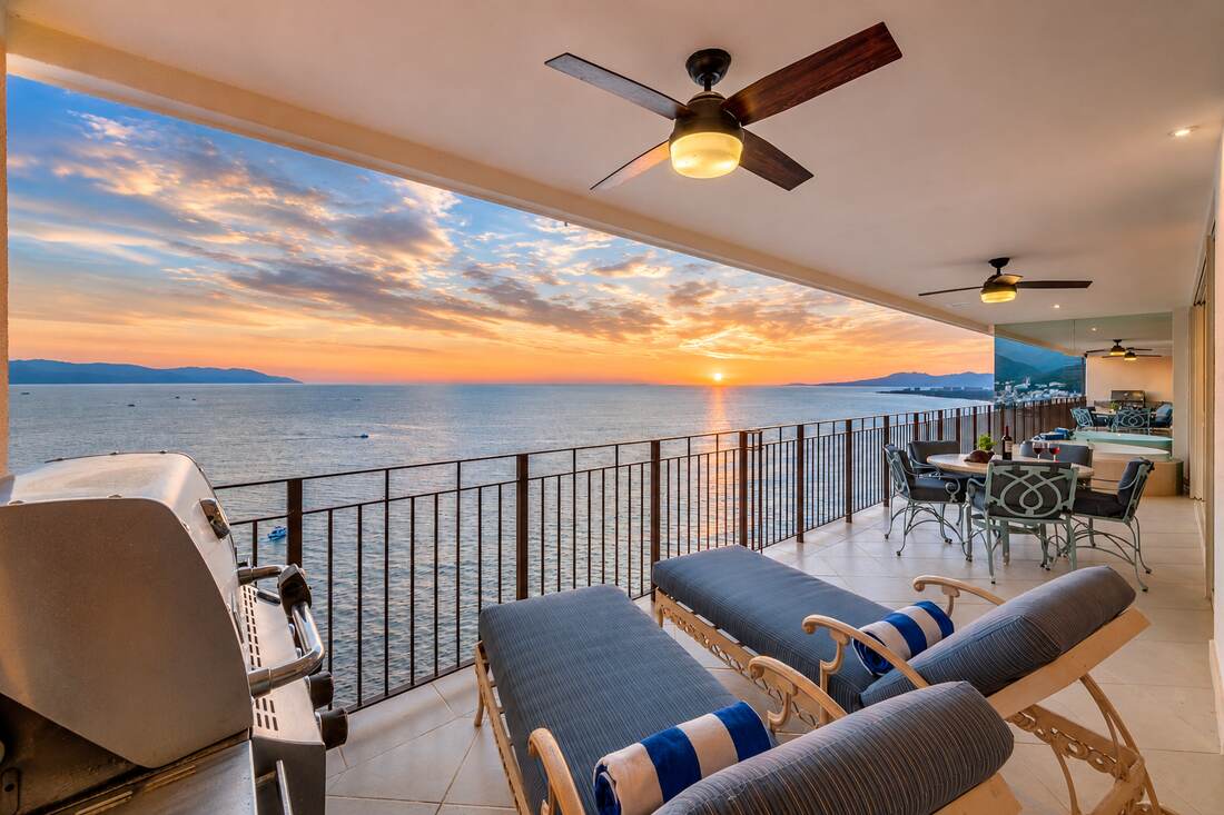 Full terrace with grill, loungers, and dining at golden hour