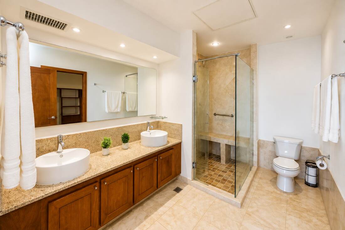 Primary bathroom with double vanity and glass shower