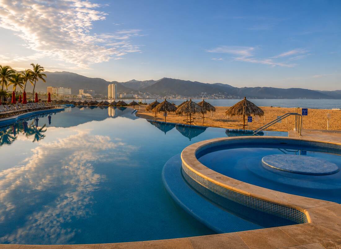 Oceanfront pool and jacuzzi at sunrise