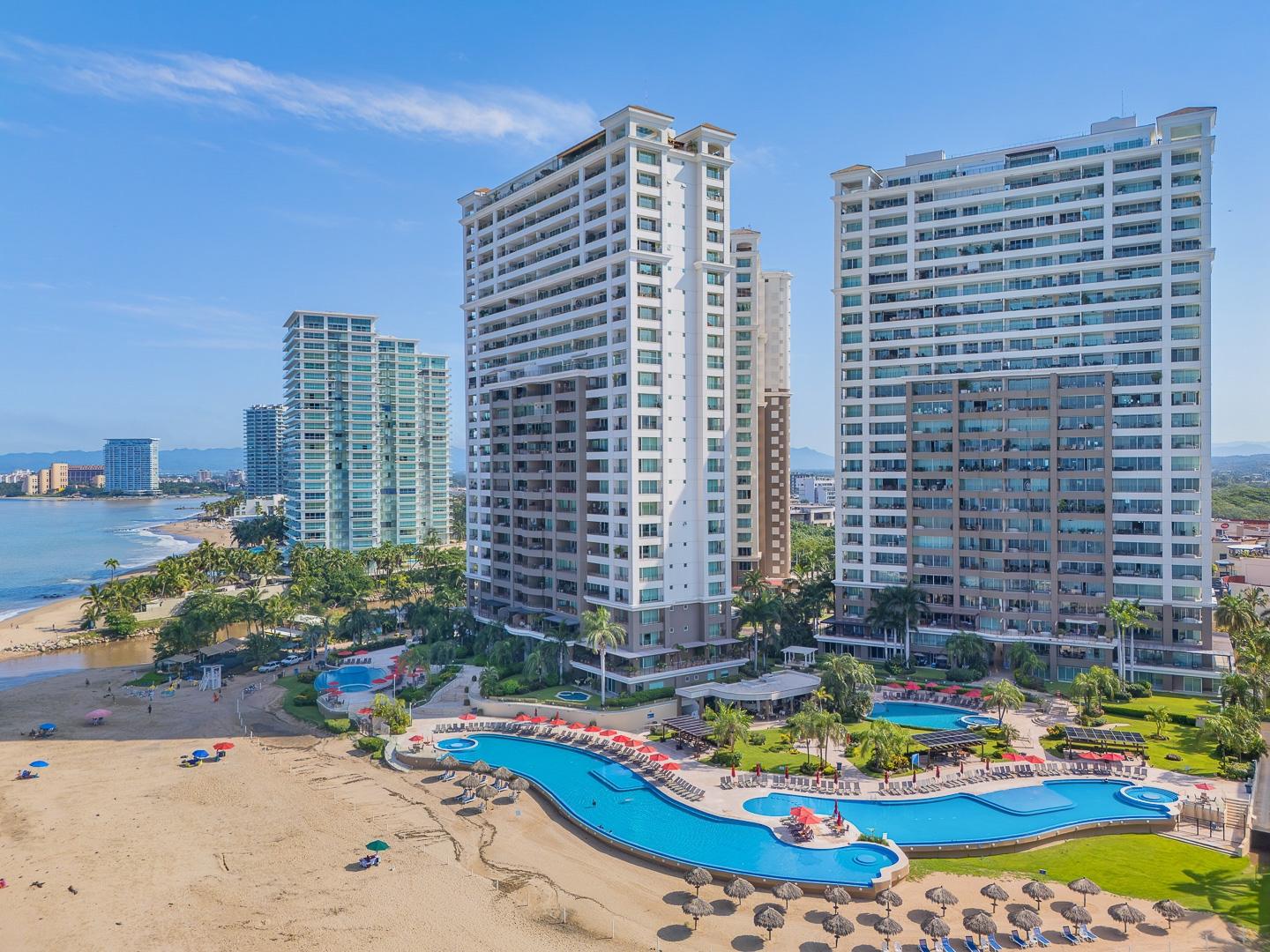 Aerial view of Grand Venetian, its pools and the beachfront in Puerto Vallarta's Hotel Zone