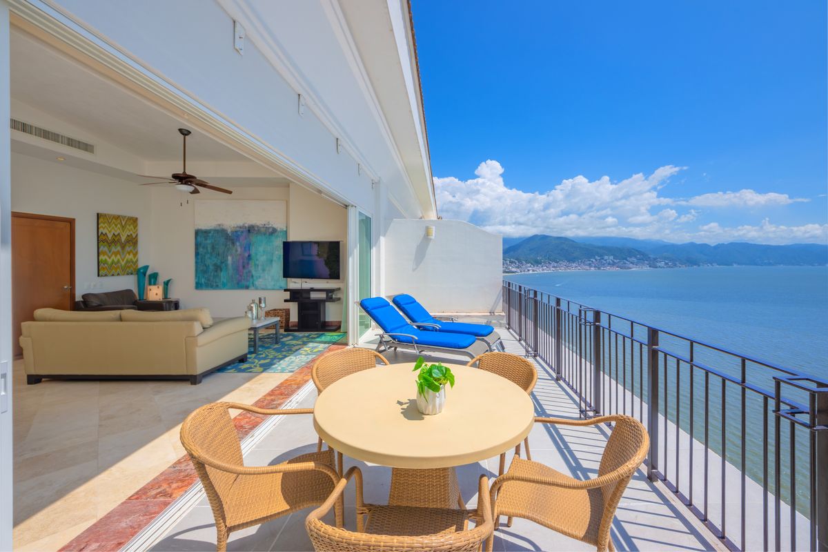 The full oceanfront terrace with dining and loungers, Penthouse 2