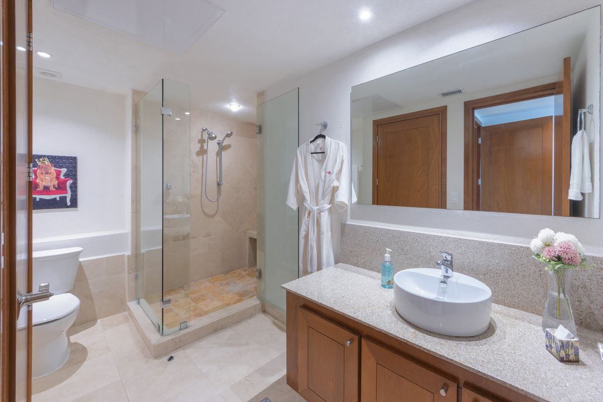 Primary bathroom with soaking tub and glass shower, Penthouse 2