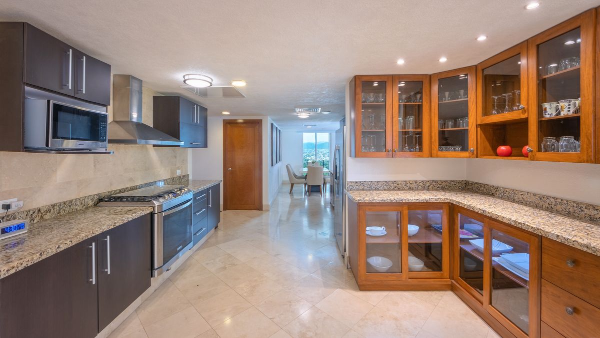 Chef's kitchen with granite counters and glass cabinetry, Penthouse 2