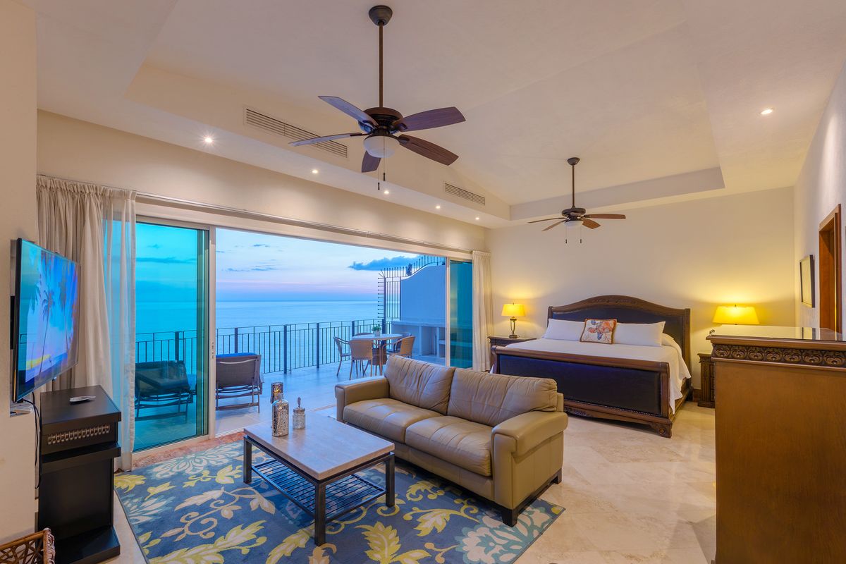 Primary suite at twilight with private terrace beyond, Penthouse 2