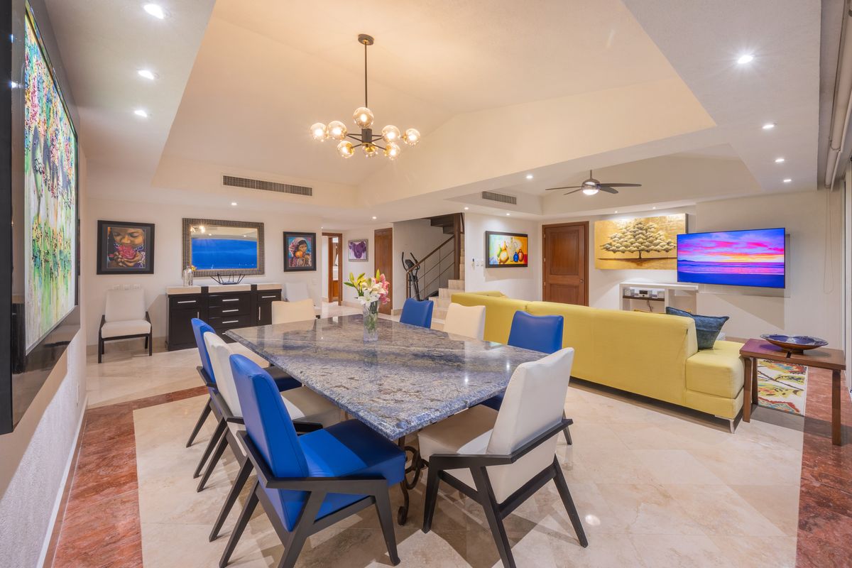 Dining room seating eight beneath the chandelier, Penthouse 2